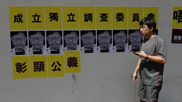 A pedestrian walks past posters with photographs of Hong Kong Chief Executive Carrie Lam demanding official investigation. Hong Kong’s protests were ignited by a now-scrapped plan to allow extraditions to the mainland. But after Beijing and local leaders took a hardline they snowballed into a wider movement calling for democratic freedoms and police accountability. With Lam seemingly unwilling or unable to find a solution, police have been left to battle the protesters. (Vincent Thian / AP)