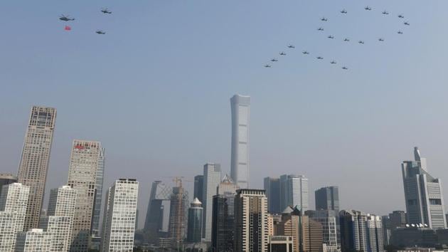 Military helicopters fly over the Central Business District in the formation of the number "70" during the military parade. “There is no force that can shake the foundation of this great nation,” Xi said from the Tiananmen rostrum where Chairman Mao Zedong proclaimed the People’s Republic of China on October 1, 1949. (REUTERS)