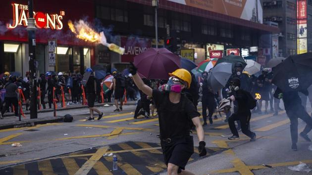 Demonstrators throw petrol bombs towards riot police during a protest in the Mong Kok district of Hong Kong. Hospital authorities said more than 70 people were admitted on Tuesday. Police made some 160 arrests throughout the day. On Wednesday, 96 protesters arrested during clashes with police on Sunday appeared in court charged with rioting, according to court documents. Their ages ranged from 14 to 39. (Chan Long Hei / Bloomberg)