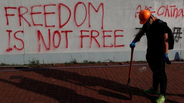 An anti-government protester walks in front of graffiti during a demonstration in Sha Tin district, in Hong Kong. The unrest in Hong Kong illustrated the challenges faced by China, which is also contending with US trade war negotiations. Despite increasing levels of violence, there is still huge public support for a movement that presents the most serious threat to Beijing’s rule since the 1997 handover. (Jorge Silva / REUTERS)