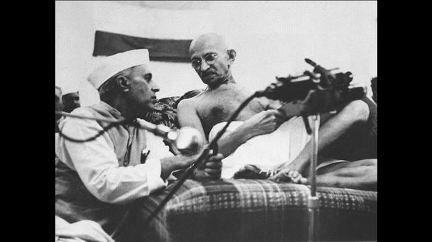 Jawaharlal Nehru (left) and Mahatma Gandhi converse at a session of the Indian National Congress in Gowalia Tank, Mumbai, India, a few hours before their arrest on August 8, 1942. A day after the All India Congress committee passed the Quit India resolution, Gandhi along with Mahadev Desai, Sarojini Naidu and Mira Behn were arrested from GD Birla’s house in Malabar hill where they were staying. (Courtesy National Gandhi Museum)