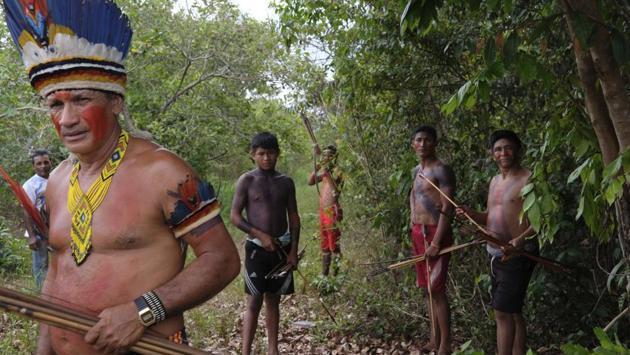 Sergio Muxi Tembe, chief of the Tekohaw village, stands with members of his tribe as they wait for police to arrive on the Alto Rio Guama indigenous reserve. “We want the federal government to assume its responsibility and guarantee the right that we have to live in our lands, to live in peace,” he said, in reference to the loggers who constantly threaten the reserve. (Rodrigo Abd / AP)