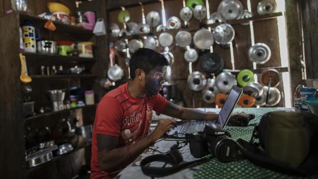 Local photographer Orerero Tembe edits his coverage of a meeting of the Tembe tribes in the Tekohaw village. In a Brazilian state ravaged by deforestation and thousands of fires, the Tembe shoot photos and video to document the cutting of trees in their land by loggers and share them on social media. (Rodrigo Abd / AP)