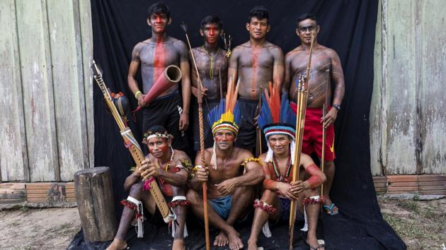 Tembe warriors pose for a portrait during a meeting of Tembe tribes in the Tekohaw village. The indigenous reserve is officially protected, but it’s constantly under siege by loggers who illegally try to extract prized hardwood. The members of the tribe hold meetings to devise plans to keep the invaders at bay. (Rodrigo Abd / AP)