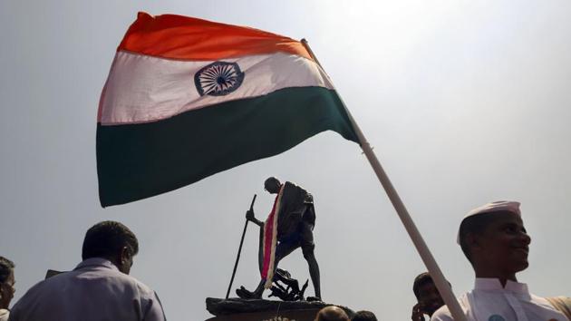 A volunteer holds the Tricolour in front of Mahatma Gandhi's statue on the occasion of his 150th birth anniversary in Chennai. Image used for representational purpose only. (Photo: PTI) A volunteer holds the Tricolour in front of Mahatma Gandhi's statue on the occasion of his 150th birth anniversary in Chennai. Image used for representational purpose only. (Photo: PTI)