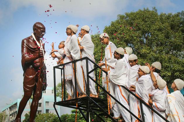 Students offer tribute to Mahatma Gandhi on his 150th birth anniversary, in Surat, on Wednesday.(PTI)