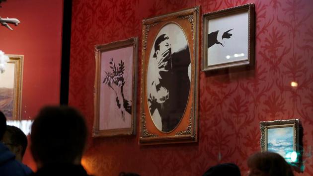 Original artworks by British artist Banksy form part of an installation inside a shop front. (REUTERS)