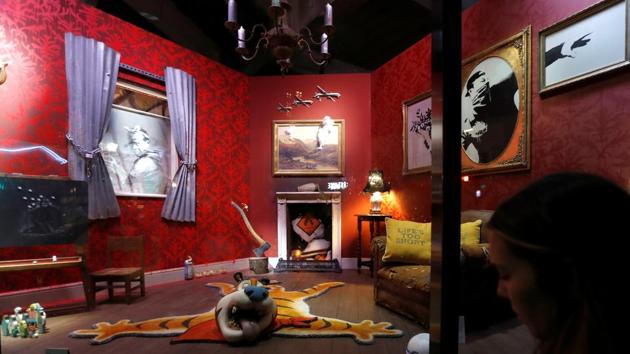 Original artworks by British artist Banksy. Framed images of his works adorn the shop walls, while a battered armchair decorated with cushions reading “life’s too short” sits in front of a fireplace. (REUTERS)