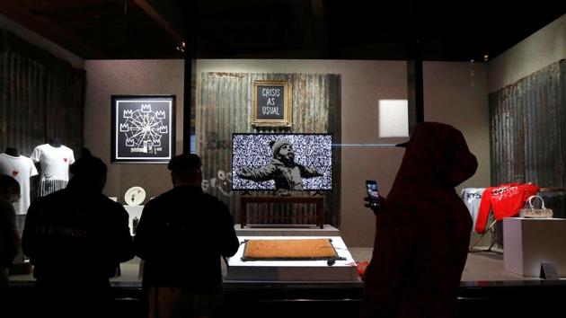 Original artworks by British artist Banksy form part of an installation inside a shop front. (REUTERS)