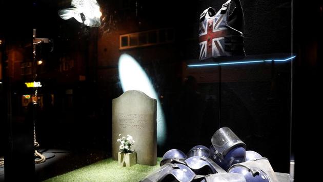 Original artworks by British artist Banksy, including a stab vest previously worn by grime artist Stormzy, form part of an installation inside a shop front, ahead of an online sale, in Croydon. (REUTERS)