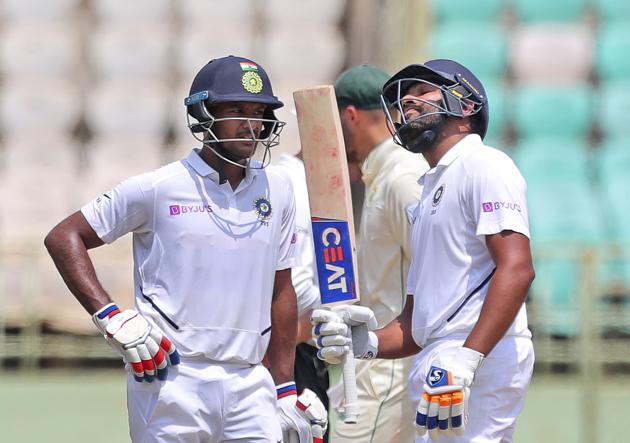 India's Rohit Sharma, right, celebrates after scoring fifty runs with Mayank Agarwal, left, during the first day of the first cricket Test match against South Africa in Visakhapatnam. (AP)