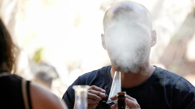 A customer smokes marijuana at the cafe. “This is a great idea and I do think that normalising cannabis is something that we should do,” said Derek Bollella, 22, a business student. “If you go to Amsterdam, they have one of these every 10 feet,” he added as he smoked a joint while munching on nachos topped with avocado. (Mike Blake / REUTERS)