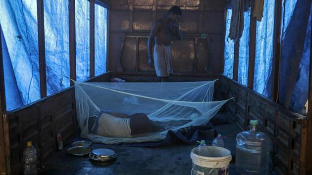 A worker sleeps inside a truck at the APMC wholesale market in Mumbai. Prices of the vegetable, as ubiquitous as spices in Indian cooking, surged more than 200% in September from previous months after flooding from heavy monsoon rains damaged crops and reduced supplies. That’s prompted the government to ban exports and crack down on hoarding to lower prices, angering farmers. (Dhiraj Singh / Bloomberg)