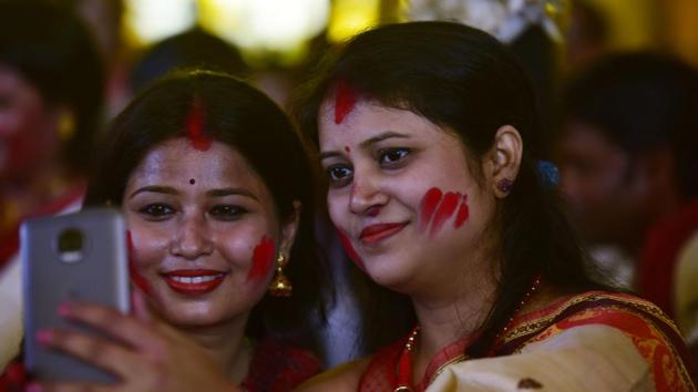 Women taking selfies during Durga Puja celebrations. (Virendra Singh Gosain/HT PHOTO)