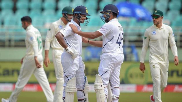 India's Mayank Agarwal is greeted by batsman Rohit Sharma after scoring a maiden century on the 2nd day of the first test cricket match against South Africa in Visakhapatnam.(PTI)