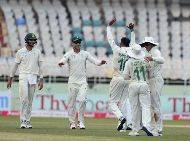 South Africa's bowler Keshav Maharaj, right, celebrates with captain Faf du Plessis, centre, after dismissing India's Ajinkya Rahane during the second day of the first cricket test match against India in Visakhapatnam. (AP)