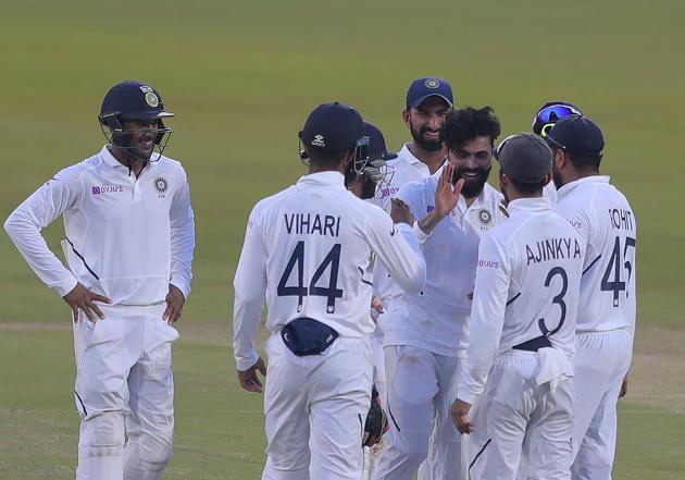 Indian bowler Ravindra Jadeja, center, celebrates with team members after dismissing South Africa's Dane Piedt during the second day of the first cricket test match against South Africa in Visakhapatnam. (AP)