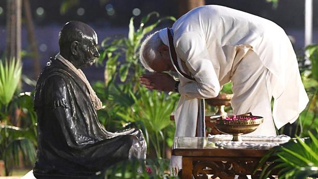 Prime Minister Narendra Modi pays homage to Mahatma Gandhi during his address, at Sabarmati Ashram, in Ahmedabad, Gujarat, on Wednesday. ‘Rural India and villages today have declared itself open-defecation free. I especially thank all the volunteers, sarpanchs (village chiefs) and all the others involved with the mission,” Modi told a gathering of 20,000 village chiefs. (ANI)