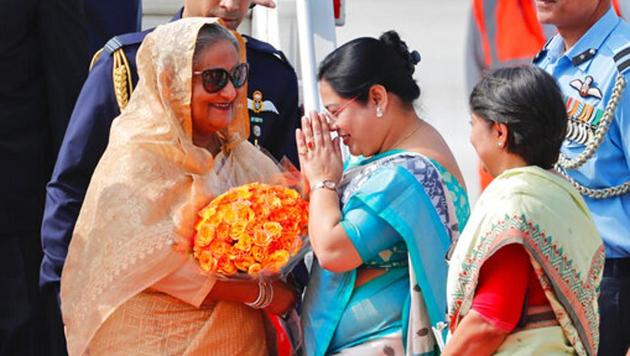 Bangladesh Prime Minister Sheikh Hasina, left is received with flowers as she arrives at the airport in New Delhi. Hasina is on a four day visit to India.(Photo: AP)
