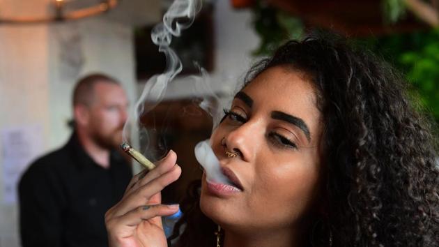 Kush Doleo smokes a joint at the Lowell Farms. For Matt Kirschner, the new eatery is long overdue and marks a major milestone for the country. “This is the greatest thing that the United States has implemented into its culture in a while,” said the 22-year-old law student as he smoked a joint with a friend at Lowell’s. (Frederic J. Brown / AFP)