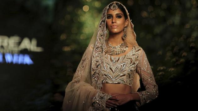 A model presents creation by designer Noreen and Neelam during the Bridal Fashion Week organized by the Pakistan Fashion Design Council in Lahore, Pakistan. (KM Chaudary / AP)