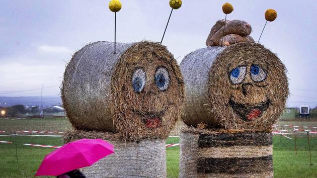 Figures made of straw bales stand on a meadow in the small village of Weiskirchen near Frankfurt, Germany. (Michael Probst / AP)