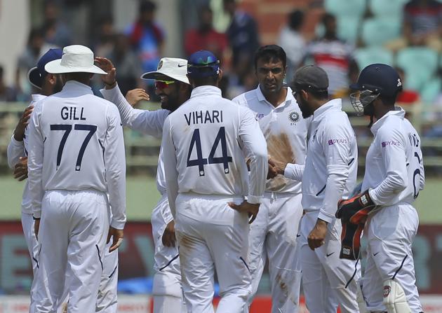 Indian bowler Ravichandran Ashwin, centre, celebrates with team members after dismissing South Africa's captain Faf du Plessis during the third day of the first cricket test match against South Africa in Visakhapatnam. (AP)