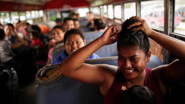 Mexicans fleeing from violence, and who are camping near the Santa Fe international border crossing bridge while waiting to apply for asylum to the US, are seen on a bus as they are moved to a shelter due a storm forecast in Ciudad Juarez, Mexico. (Jose Luis Gonzalez / REUTERS)