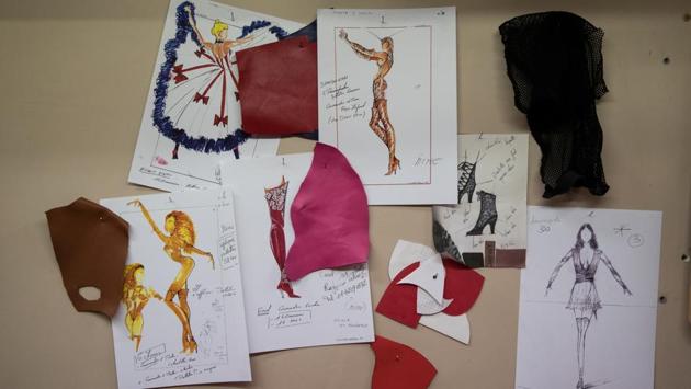 Drawings of the costumes for the "Feerie" review are seen pinned on the wall at the Clairvoy shoemaker workshop in Paris. Each show requires 1,000 outfits, all crafted in the workshops that have been supplying the Moulin Rouge for decades. Each dancer has to make between 10 and 15 costume changes per show, with about 90 seconds to complete each one before they have to be back out on stage. (Philippe Wojazer / REUTERS)