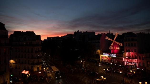 The sun sets over the Moulin Rouge. (Philippe Wojazer / REUTERS)