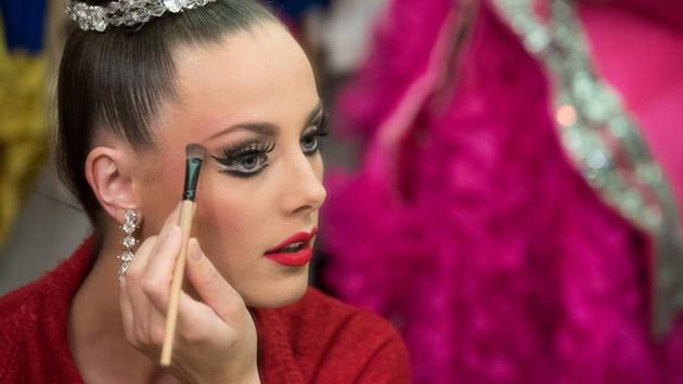 Dancer Claudine Van Den Bergh, 27, puts on her make-up before entering the stage. “The whole team including dancers, aides and technicians need to be very organised,” said the Irish dancer who has been dancing at the Moulin Rouge for seven years. “A little mistake or a little delay and you can miss your entrance. You really need to be at the right time at the right place.” (Philippe Wojazer / REUTERS)