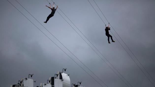 Fans ride on a zip line mounted in front of the main stage of the Rock in Rio festival at the Olympic Park, Rio de Janeiro, Brazil. The week-long Rock in Rio festival started September 27, with international stars as headliners, over 700,000 spectators and social actions including the preservation of the Amazon. (Mauro Pimentel / AFP)
