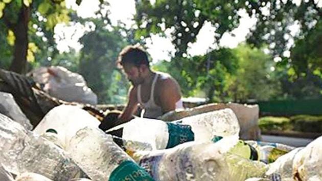 A scrap vendor sorting disposable plastic bottles. Uncollected plastic waste is a massive problem. A scrap vendor sorting disposable plastic bottles. Uncollected plastic waste is a massive problem.