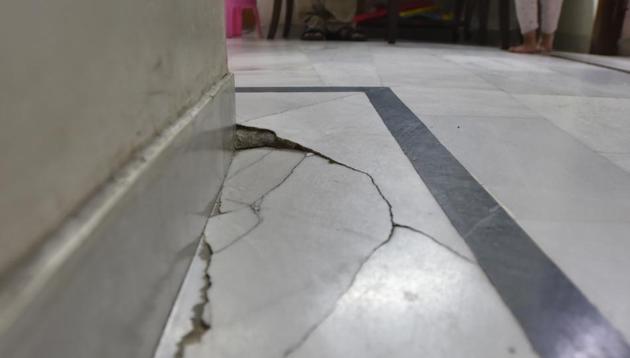 Cracks seen on the floor of a house at Begumpur Village, in New Delhi. Residents of the area say the cracks have appeared due to the Metro trains passing in the tunnel underneath their houses. (Sanjeev Verma/HT PHOTO) Cracks seen on the floor of a house at Begumpur Village, in New Delhi. Residents of the area say the cracks have appeared due to the Metro trains passing in the tunnel underneath their houses. (Sanjeev Verma/HT PHOTO)