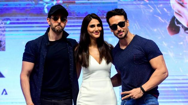 Bollywood actor Hrithik Roshan (L), actress Vaani Kapoor (C) and actor Tiger Shroff (R) pose for photographs during the promotion of action thriller Hindi film War.(AFP)