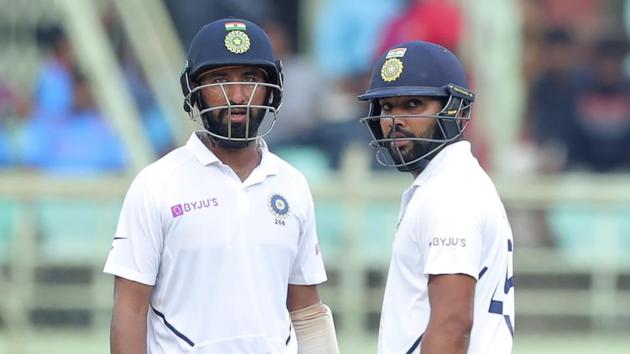 India's Rohit Sharma, right, and Cheteshwar Pujara stand in the field during the fourth day of the first Test.(AP)