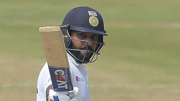 India's Rohit Sharma raises his bat after scoring fifty runs during the fourth day of the first Test.(AP)