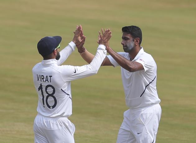 Indian bowler Ravichandran Ashwin celebrates with captain Virat Kohli after dismissing South Africa's Keshav Maharaj during the fourth day of the first cricket test match against South Africa in Visakhapatnam. (AP)