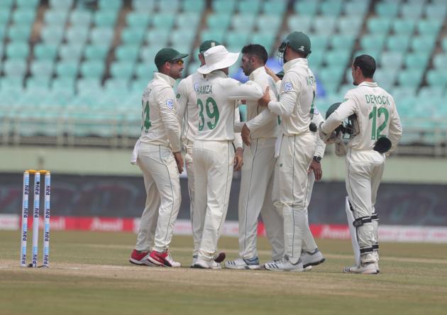 South Africa's bowler Keshav Maharaj, without cap, celebrates with team members after dismissing India's Mayank Agarwal during the fourth day of the first cricket test match against India in Visakhapatnam. (AP)