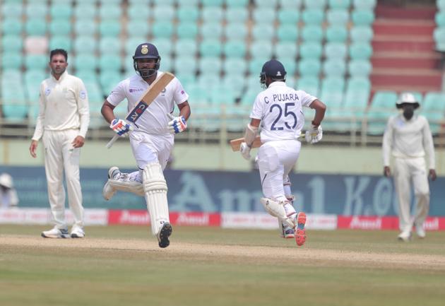 India's Rohit Sharma, left, and Cheteshwar Pujara run between the wickets during the fourth day of the first cricket test match against South Africa in Visakhapatnam, India, Saturday, Oct. 5, 2019. (AP Photo/Mahesh Kumar A.) (AP)