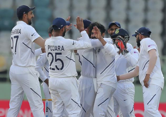 Indian bowler Ravindra Jadeja, without cap, celebrates with team members after dismissing South Africa's Dean Elgar during the fourth day of the first cricket test match against South Africa in Visakhapatnam. (AP)