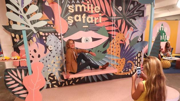 A woman poses for a photo during a visit to the Instagram museum "Smile Safari". (REUTERS)