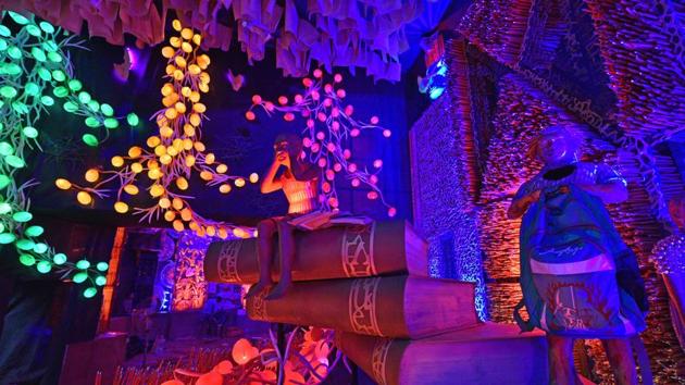 The 70th Durga Puja pandal at Bosepukur Shitala Mandir, created by artist Debasis Guchait, is themed as ‘Khuje dekho aapon aalo’ (Look for your own light). With lights of different colours, the pandal depicts children burdened with their academic syllabus, school bags and other items; things that kill their imagination as they are pushed into the mad rat race to build a career. (Samir Jana / HT Photo)