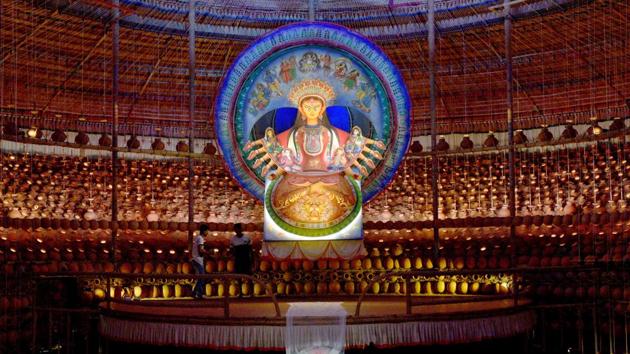 The theme for the 33rd Durga Puja pandal at Naktala Udayan Sangha is ‘birth.’ It refers not to the biological birth, but the spiritual birth. It has been created by artist Bhabotosh Sutar who also made the idol. The pandal has been decorated with earthen pots, symbolising the womb of nature. (Samir Jana / HT Photo)