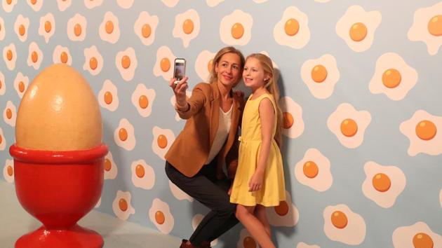 Visitors take photos at the Instagram museum "Smile Safari" that recently opened in Brussels. (REUTERS)