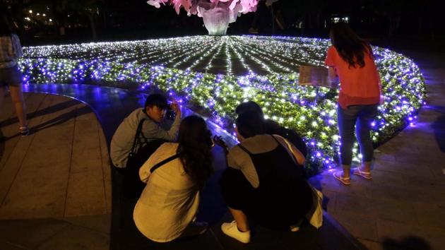 Visitors take photos of art work at the Nuit Blanche Taipei 2019 in Taipei, Taiwan. (AP)