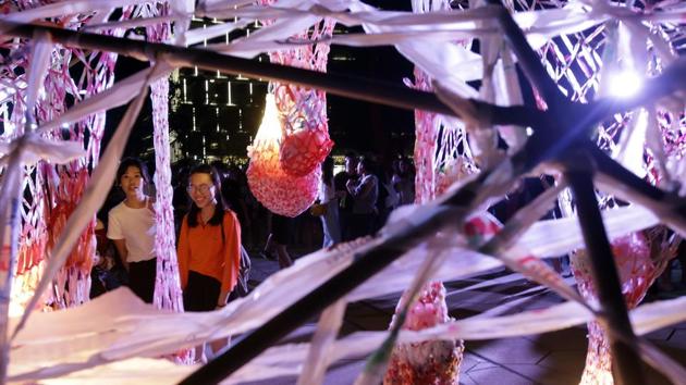 Two women look at the work of Taiwanese artists Peng yu-hong and Yang Fang-Yi. (AP)