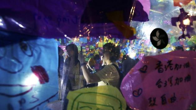A visitor takes photos of Japanese artist Asozaki Michiyoshi's work 'Dome Project,' at the Nuit Blanche Taipei 2019 in Taipei, Taiwan. (AP)