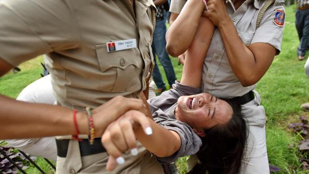 Delhi Police personnel detain a member of Tibetan Youth Congress during a protest outside the Chinese Embassy on the occasion of 70th foundation anniversary of the People’s Republic of China, at Shantipath, in New Delhi. (Amal KS / HT Photo)