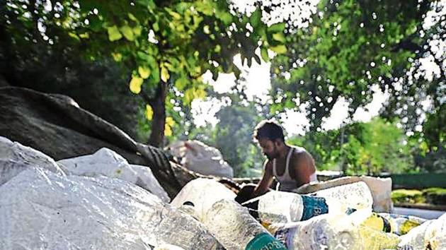 A scrap vendor sorts plastic bottles in New Delhi.(File Photo)